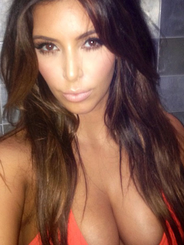 kim-kardashian-shows-cleavage-in-her-orange-bikini.jpg