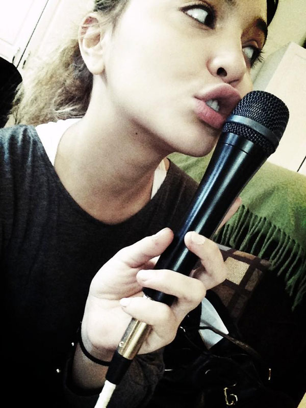 stella-hudgens-holding-a-microphone-against-her-lips-twitpic.jpg
